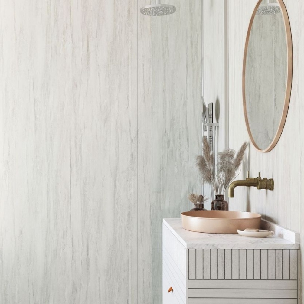 Lifestyle image of the Showerwall Laminate White Charcoal 2440mm x 900mm Square Cut Ply Wall Panel - SW70 installed on bathroom walls with traditional fixtures, such as vanity unity, countertop basin, and wall-mounted basin spout